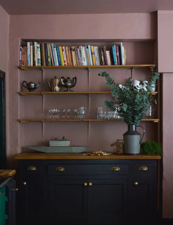 Kitchen With Navy Cabinet With Gold Fittings And Mellow Purple Walls.