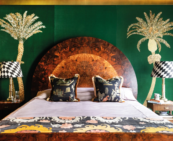 Green and gold Hand-Embroidered Wallcovering by de Gournay framing bed frame in bedroom.