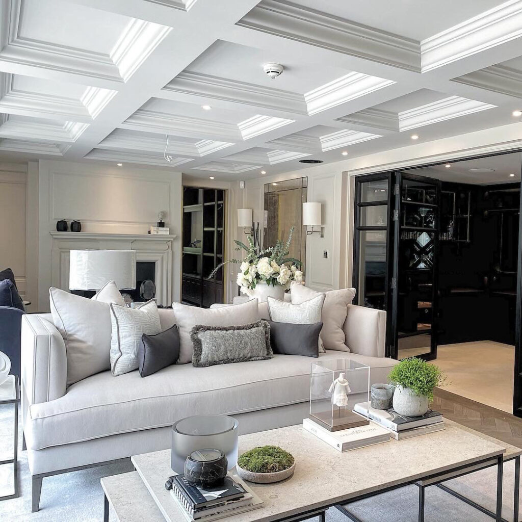 Luxurious cream-toned living room with coffered ceiling and tailored furnishings in a private estate interior.