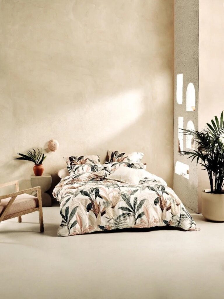 Minimalist bedroom with plaster-textured walls painted in Bauwerk’s Calm limewash, styled with soft neutral tones, organic textures, and natural daylight.