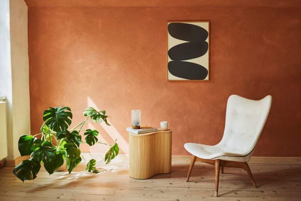 Bright and inviting dining area with warm-toned Casa limewash walls from the Hoxton x Bauwerk collection, styled with mid-century furniture and golden hour lighting.